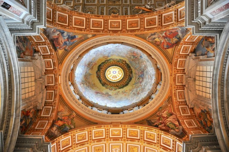 Intricate dome in Vatican City adorned with stunning religious frescoes and architectural beauty.